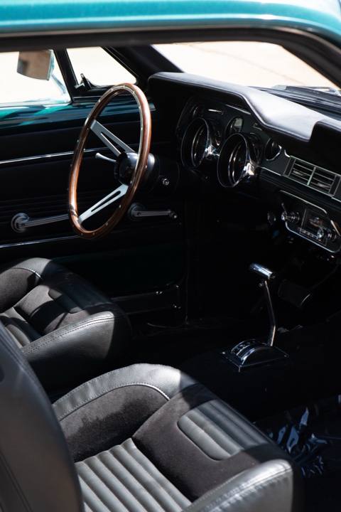 Black interior and wood-rim steering wheel in the 1967 Mustang