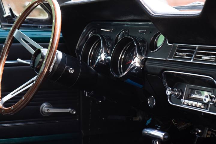 Dash, gauges, and wood-rim steering wheel in the 1967 Mustang