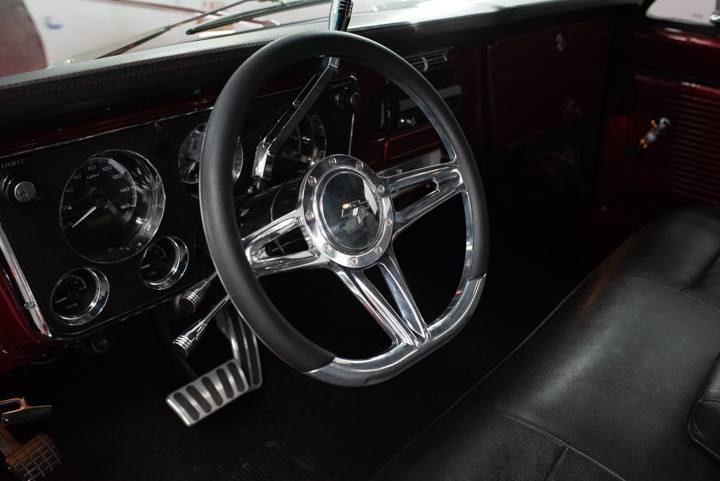 Black bench-seat interior with Dakota Digital gauges in the 1970 C10