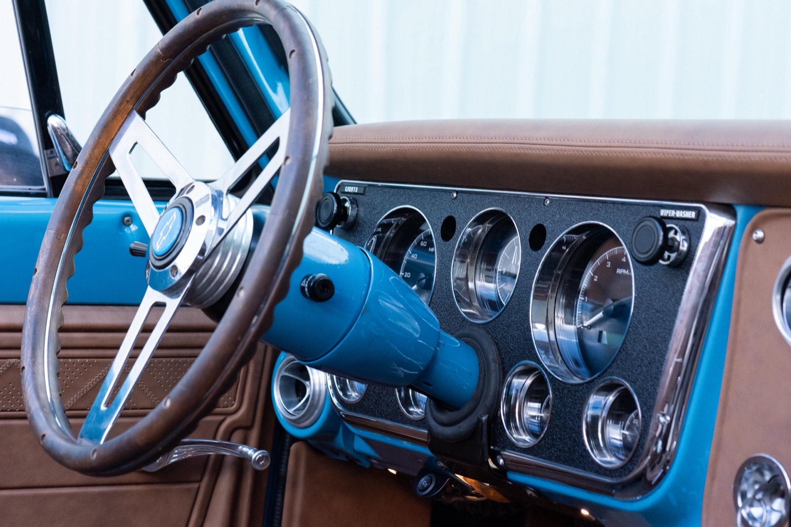 Steering wheel and gauges in the custom interior of the light blue 1972 K5 Blazer