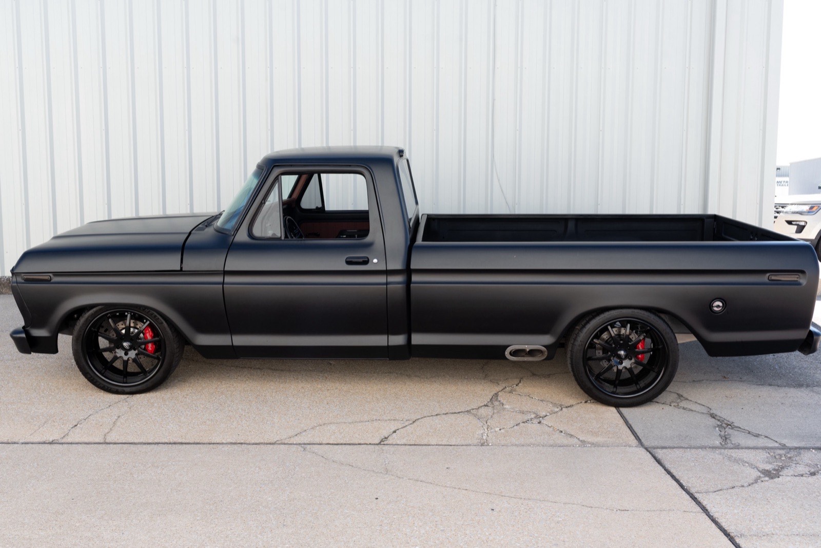 Side profile of the satin black 1973 F-100 long bed
