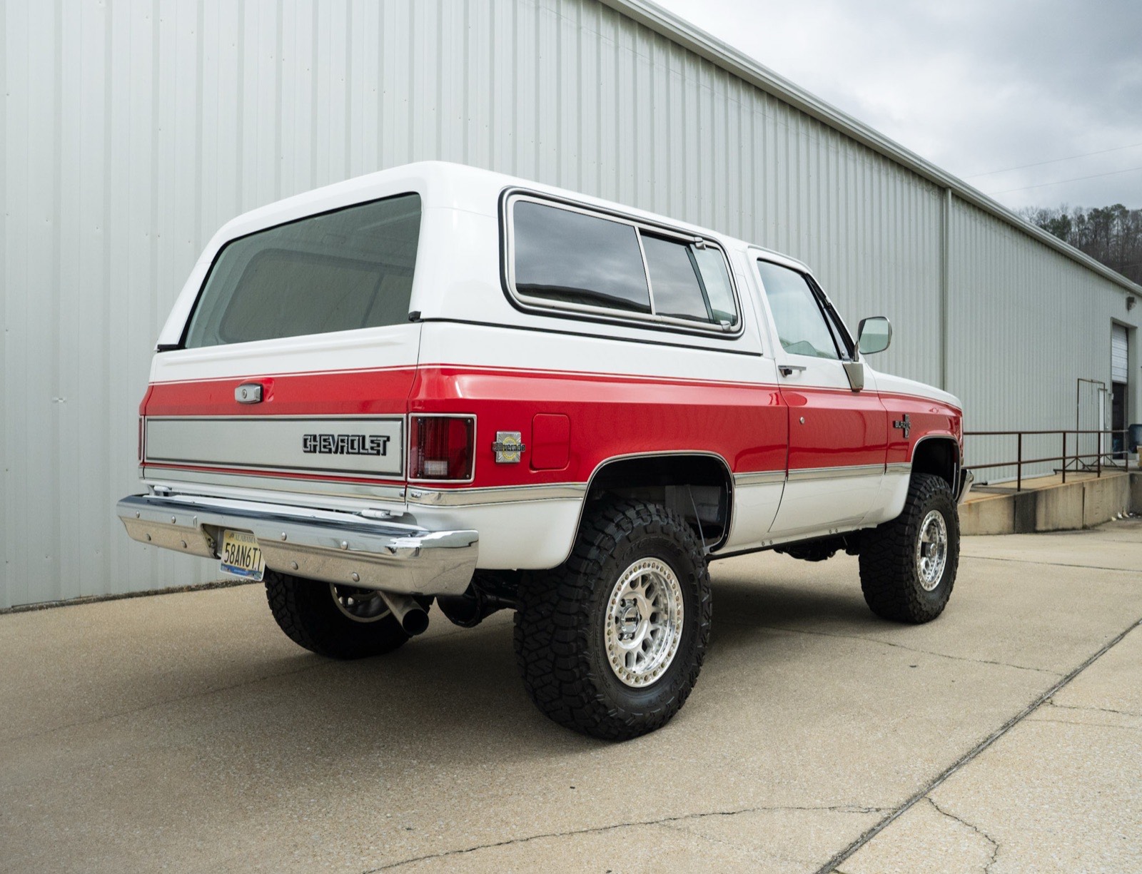 Rear three-quarter view of the 1984 K5 Blazer in Arctic White with Viper Red accents